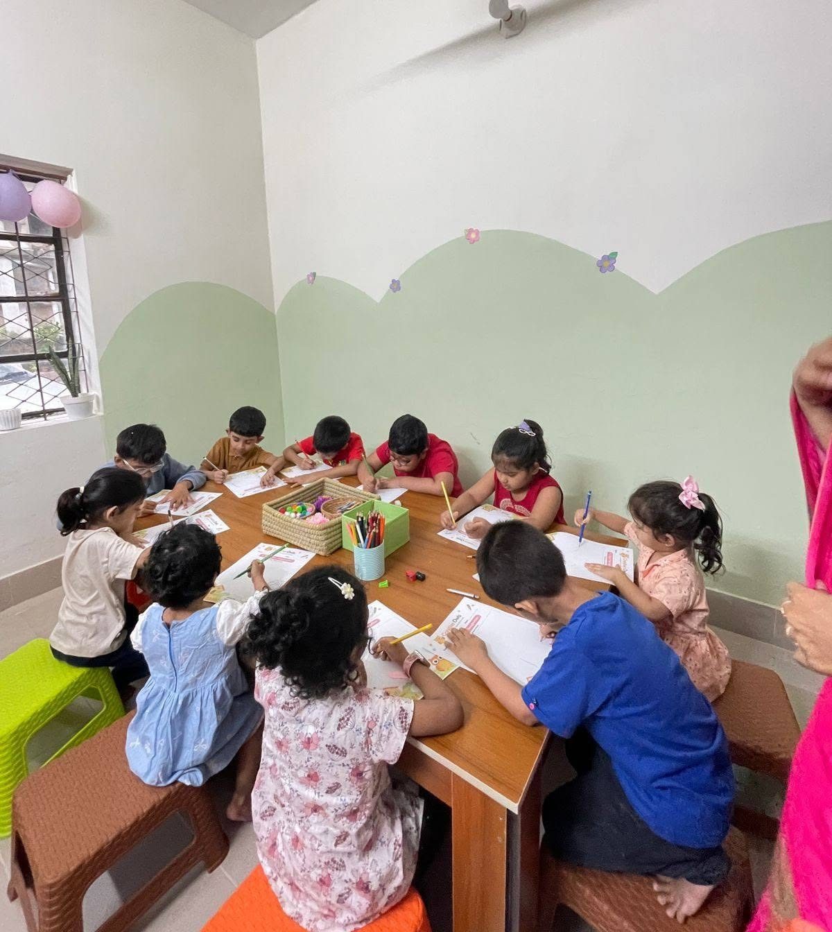 A table of Owlets coloring together during a Creative Owls session